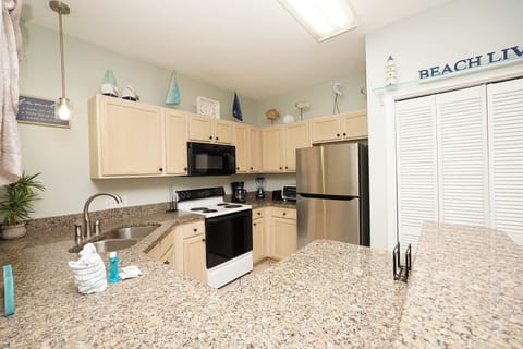 Whip up your morning coffee in this bright, fully-equipped kitchen with granite countertops and stainless steel appliances.