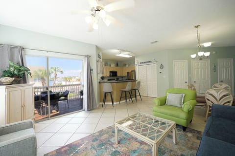 Relax in your bright living space with waterfront views, where comfortable seating and an open kitchen invite you to unwind.