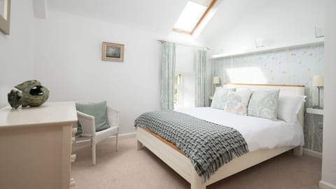 Budle Bay Loft - bedroom two with double bed and blue tones
