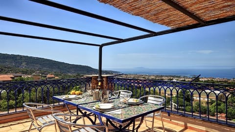 Your large private terrace, with a table and chairs, deckchairs and amazing panoramic views of the Gulf of Sorrento