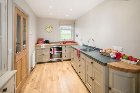 Barley Hill Cottage - the Chalon-style handmade kitchen with door leading to the utility/boot room