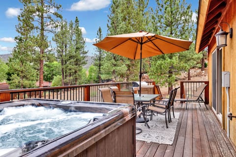 Private outdoor hot tub, surrounded by tall pines, perfect for relaxing under the trees after a day of adventure—enjoy peaceful forest views, fresh air, and a truly rejuvenating stay.