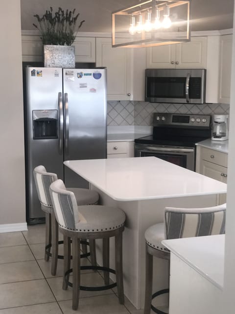 Upgraded kitchen with all new appliances, countertops, cabinets, and bar stools!
