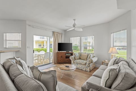 Relax in your bright, airy living room with plush seating and entertainment center, perfect for unwinding after beach days.