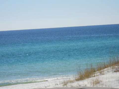 Our crystal while sand beach Just steps from our condo and enjoy.....
