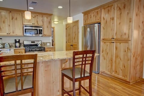 Breakfast bar and kitchen. Deluxe, counter-depth fridge and custom cabinetry