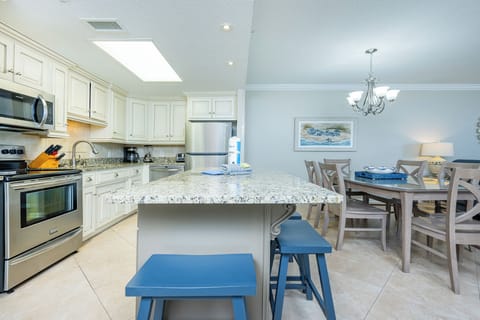 Enjoy meals at the granite island or dining table, surrounded by light and inviting decor in this spacious kitchen area