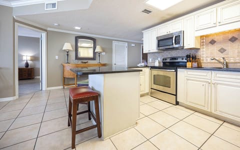 Gather around the breakfast bar for casual meals, enjoying the inviting space with ample natural light