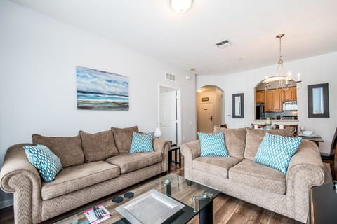 This cozy living area is strategically located beside the dining table and kitchen, providing effortless access to the private balcony for relaxing outdoor moments.