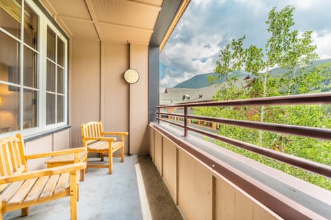 Relax on your private balcony with mountain views, where wooden chairs await your morning coffee and evening unwinding moments.