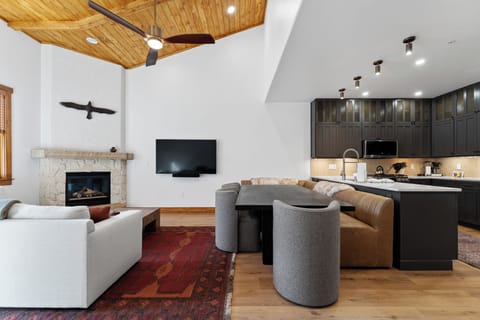 Unwind in your spacious open-plan retreat where modern luxury meets mountain charm, complete with cozy fireplace and gourmet kitchen.