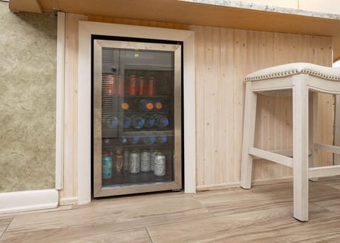 Enjoy refreshing beverages from the sleek mini-fridge, conveniently located near the stylish bar seating