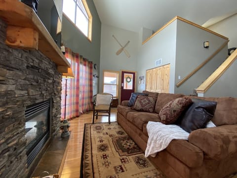 Main living room. Cozy up to the fireplace. Stairs leading up to loft.