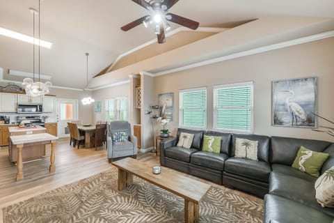 Living area looking into kitchen - Relax and unwind in this inviting living area, featuring direct access to the dining space and outdoor deck