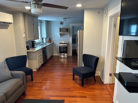 Den and kitchen are with hardwood floors.
