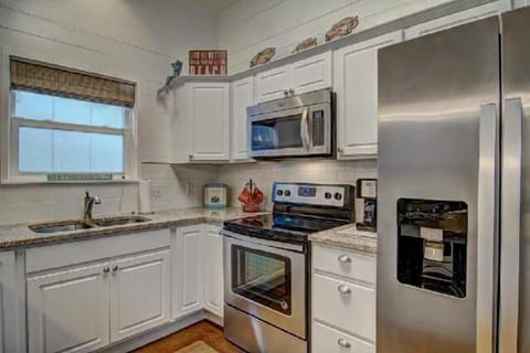 Kitchen - This cozy coastal kitchen features stainless steel appliances and ample cabinet space