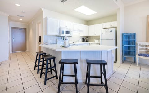 Gather around the inviting kitchen with bar stools, perfect for casual meals or coffee and conversations