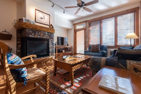 Cozy up by your stone fireplace where warm sunlight filters through your windows, creating the perfect mountain retreat atmosphere.