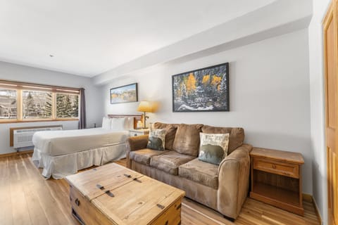 Unwind in your mountain retreat with cozy furnishings, stunning alpine views, and warm wood accents creating the perfect après-ski sanctuary.