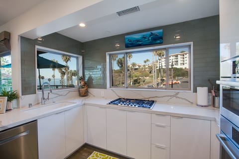 Light and bright kitchen with all new stainless appliances and custom cabinets.