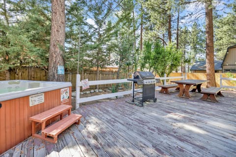Private outdoor hot tub, surrounded by tall pines, perfect for relaxing under the trees after a day of adventure—enjoy peaceful forest views, fresh air, and a truly rejuvenating stay.