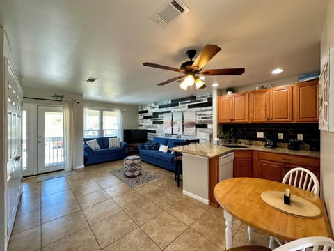 Your open-concept living space flows from kitchen to living room, perfect for relaxing on comfortable sofas after preparing meals.