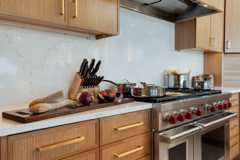 Wolf Range with 4 burners, a griddle, a grill and two electric ovens.