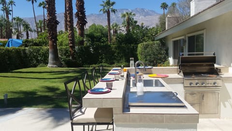 Outdoor kitchen and bar with grill, sink and chilly bin
