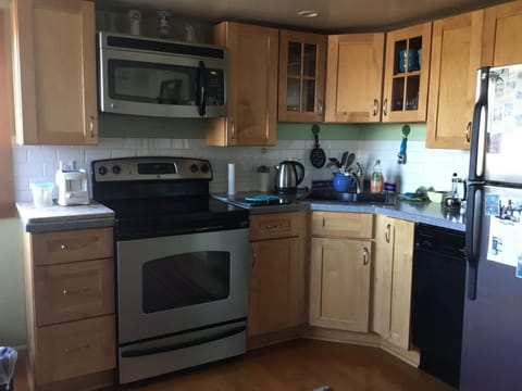 Kitchen, stocked with cooking condiments and continental breakfast.