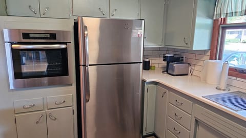 Appliances include a stand alone stove, cooktop, dishwasher, and fridge.