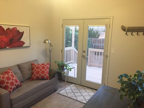 Sitting room with pull-out couch, dining table and kitchenette.
