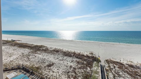 Gaze at the shimmering waters and expansive shoreline from your inviting balcony, perfect for relaxation