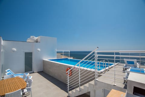 Outdoor Relaxation area with table, chairs, sun loungers and barbecue