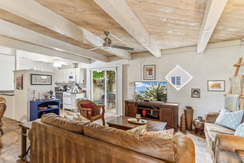Living room with 50" SMART TV and access to the patio from the kitchen