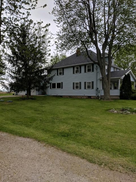 View from end of driveway. Large farmhouse with ample outdoor space
