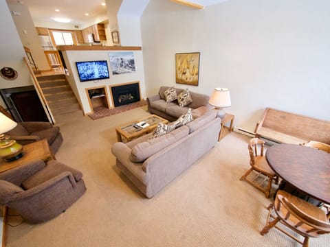 Living Room Area - Enjoy the spacious and accommodating living room area with a cozy fireplace, TV, and a gaming area that looks out onto the Breckenridge Ski Resort.