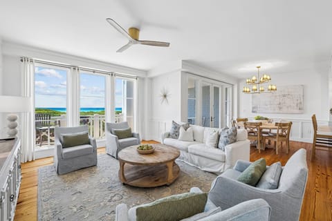 Unwind in your bright coastal living space with sweeping sea views, comfortable seating, and an open layout that flows seamlessly to your private balcony overlooking turquoise waters.