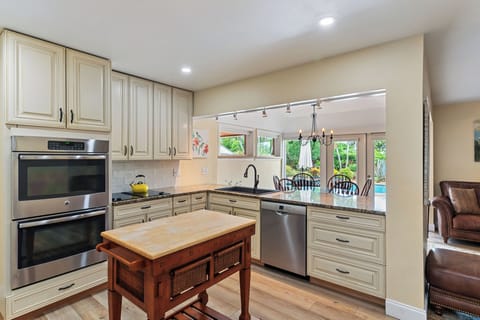 Full kitchen on 3 bedroom side with Bosch dishwasher, overlooking pool