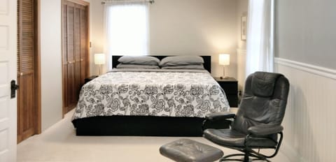 King size bed with memory foam mattress in primary bedroom located upstairs.