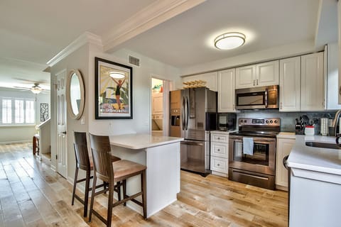 Brand new kitchen with entrance to laundry room