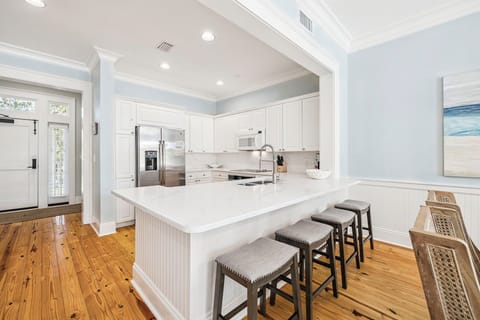 Your gourmet kitchen awaits with gleaming quartz counters, professional appliances, and a spacious island perfect for morning coffee or evening gatherings.