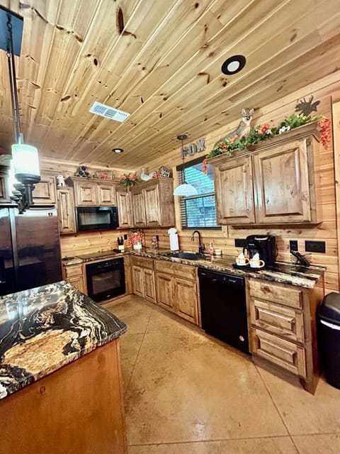 Kitchen area with stove, refrigerator, microwave and dishwasher