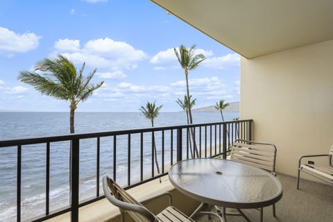 Stunning oceanfront balcony with swaying palms and soft ocean breezes. Enjoy morning coffee or sunset cocktails from your private outdoor retreat overlooking turquoise waters.