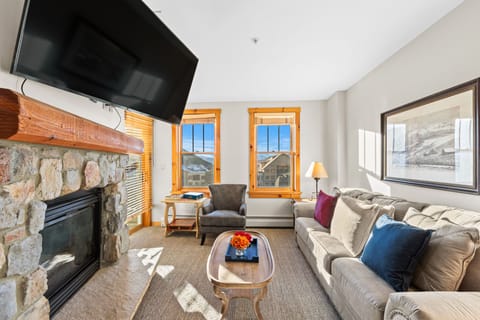 Cozy up in your mountain retreat with a crackling stone fireplace, plush sectional sofa, and stunning alpine views from every window.