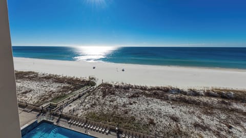 Gaze at the tranquil waters and beach from your balcony, perfect for unwinding under the sun