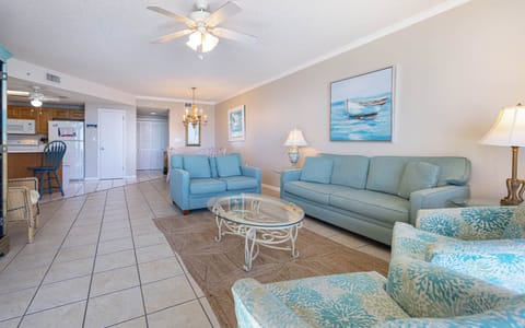 Unwind in the comfortable living area with soft seating, sofa with queen sleeper, stylish coffee table, and coastal decor