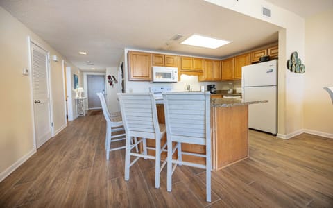 Gather around the kitchen bar with seating for casual meals and enjoy the open layout that enhances your stay