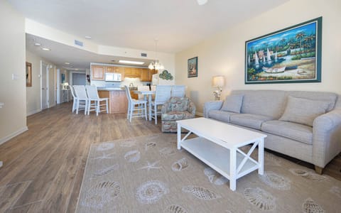 Relax in the spacious living area featuring a comfortable sofa with queen sleeper, a charming rug, and a dining space