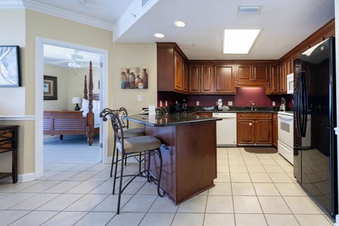 Enjoy cooking in the spacious kitchen with dark wood cabinetry, granite counters, and convenient bar seating