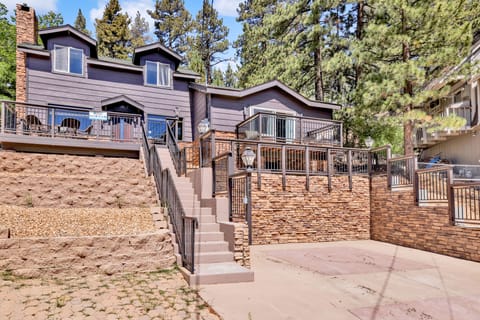 Welcoming cabin entry surrounded by towering pine trees, offering fresh mountain air and a peaceful forest setting—the perfect first impression for your Big Bear Lake getaway.